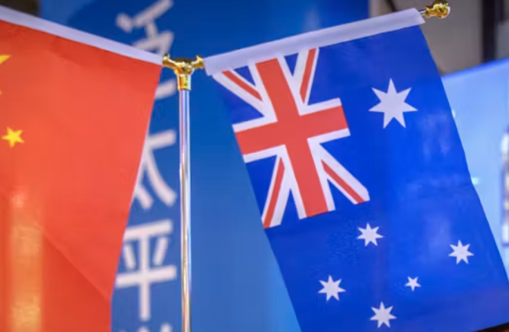 Chinese and Australian flags with wine posters in background 