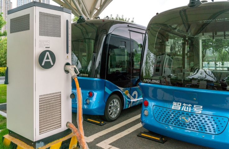 Pictures busses being fueled at a gas station 