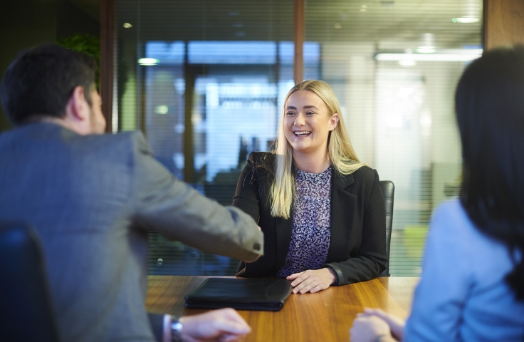 female student shakes hand