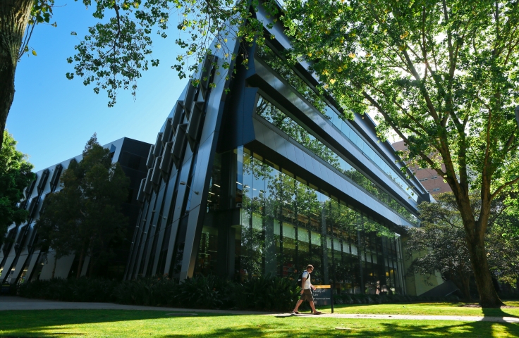 Man walking by UNSW Law Building 