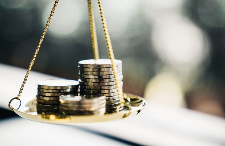 Stacks of coins resting on scales 